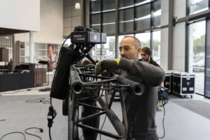 Technicien réglant un projecteur sur une structure pendant le montage d’un événement professionnel