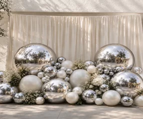 Décoration élégante avec ballons chrome argent et fleurs blanches pour réception haut de gamme