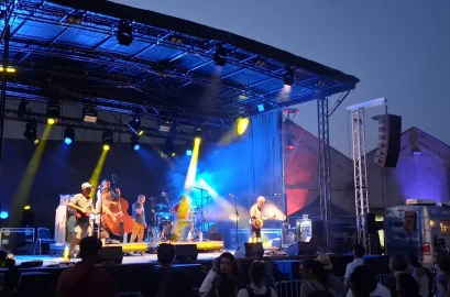 Scène mobile de festival éclairée en contre-jour bleu et faisceaux dorés